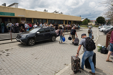 Displaced Ukrainians arrive at Przemyśl station for the train to Ukraine. Since the start of the Ukraine-Russia conflict, nearly 7 million Ukrainians have been displaced. Now entering its fourth year, the war has led to a growing trend of refugees making occasional return trips through Przemyśl, the Polish city where trains depart for Ukraine.