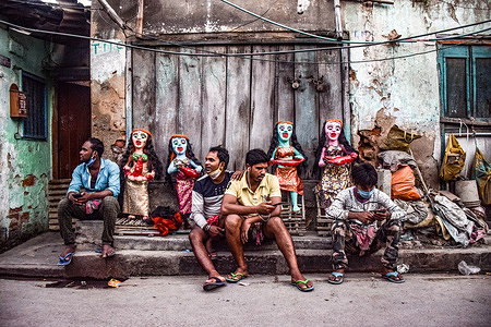 People sit in front of clay idols.Bhoot Chaturdashi or Narak chaturdarshi is observed on the 14th day of Krishna Paksha in Hindu Month. It comes before the day of Diwali.