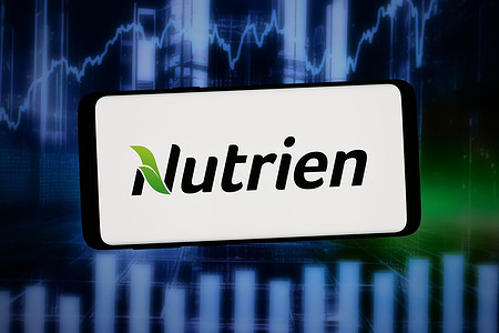 In this photo illustration, the logo of Canadian fertilizer company Nutrien Ltd. is displayed on a smartphone in front of abstract background on computer screen.