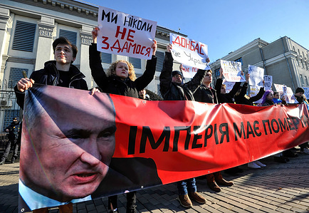Ukrainian protesters seen holding a banner and placards expressing their opinion during the rally called "Empire must die" near the Russian embassy.On February 21, Russian President Vladimir Putin announced the recognition of independence while Donetsk and Luhansk rebel republics protested Immediately after Putin's statement, a wave of indignation from Western countries like the United States and Britain have promised tough sanctions against those involved in recognizing the militants. President of Ukraine Volodymyr Zelensky , reacting to Putin's decision, stressed that we are talking about a violation of the integrity of Ukraine and the actual withdrawal from Minsk accords.