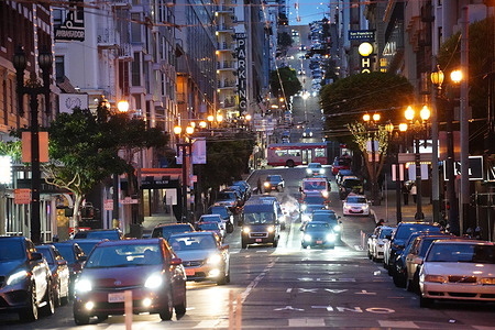 Cars are seen driving on the street in San Francisco. San Francisco is the important city in the United States of America, here is the center of economic and technology in California. In San Francisco. most people are busy and the traffic is heavy here.
