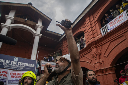 A Fire and Emergency official instructs the firefighters as they participate in a civil defence mock drill inside the premises of an office complex in Srinagar, the capital city of Kashmir. India conducted a large-scale civil defense drill titled 'Operation Shield' on May 31 across all districts along its western border, including Indian-administered Kashmir, to test readiness for potential hostile attacks. The mock drills, organized by the Ministry of Home Affairs, included simulations of air raids, drone and missile strikes, blackouts, troop mobilization, mass casualty management and evacuation of civilians. Civil and military agencies, along with youth volunteers, will participate in the coordinated response. The exercise aims to strengthen security and emergency response in vulnerable border regions.