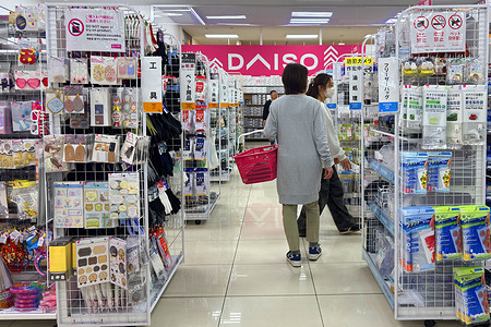 People shop at a Daiso 100-yen store in a shopping mall in Tokyo’s Shinagawa Ward, Japan. Daiso is one of Japan’s largest discount retailers, offering a wide range of affordable household goods, stationery, food items and daily necessities, with most products priced at around 100 yen, making it popular among shoppers seeking convenience and low-cost items.