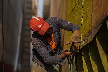 A dockyard worker welds a section of a ship's hull on the banks of the Buriganga River in Dhaka.
Rivers are the lifeblood of the delta nation of 168 million people where much of the low-lying land is accessed via boat, with Bangladesh's strong economic growth of recent years fuelling more investments in new and bigger ships. Twenty-eight dockyards occupying 30.96 acres of the Buriganga foreshore have been in operation for the last 50 years without any authorization or guidelines, polluting the river and encroaching into the riverbank, reducing its navigability.