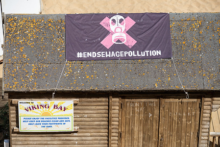 The 'End Sewage Pollution' banner is placed on the roof of the beach hut in Broadstairs. Sewage spilling is a very serious problem in the UK. The water companies released raw sewage into waterways for a record 3.61 million hours in 2024. This data has been released by the Environment Agency to raise awareness and concern about the impact of the sewage pollution on the environment and public health.
