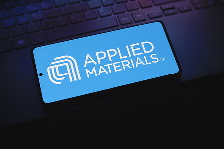In this photo illustration, the Applied Materials logo is displayed on a smartphone screen.