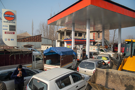 People wait with their vehicles in a queue to refill fuel tanks at a fuel station. Petrol stations in various Indian states are witnessing long queues as a result of continuous protests by truck and bus drivers across the country against the new panel law on hit-and-run cases. The newly established Bharatiya Nyaya Sanhita law, which repealed the British-era Indian Penal Code, imposes a 10-year prison sentence and a 184.76 US dollars fine for escaping an accident scene and failing to report the incident.