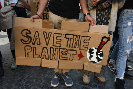 A man is seen holding a placard reading 'Save the planet' during the protest.
Dozens of young people gathered in central Barcelona to protest against the government’s lack of action on the climate change and destruction of the environment.