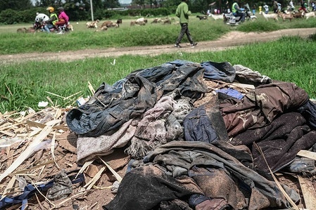 A man seen walking past a pile of textile waste dumped besides the road. Rising demand for fast fashion, much of it made from polyester is driving a surge in textile waste shipped to Global South countries like Kenya as second-hand clothing. Much of it is difficult to recycle and ends up polluting the environment, environmentalists now calling for stronger controls on transboundary movement.