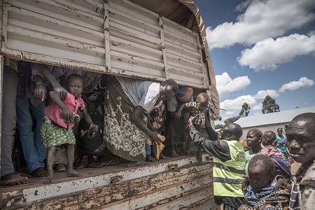 A member of the Danish Refugee Council seen assisting South Sudanese refugee minors to get off the truck which transported them to the Kuluba refugee reception center where they are to be registered by the UNHCR.
The Kuluba refugee reception center is one of many reception centers in northern Uganda specially built to handle the hundreds of thousand of South Sudanese refugees influx. The reception center is where refugees are being registered by the UNHCR as refugees officially and they are only going to be staying here for 24-48 hours before being transferred to more permanent refugee settlements.