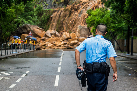 A police officer inspects a landslide in Shau Kei Wan. Hong Kong experienced its heaviest rainfall since records began, with a Black Rain Warning Signal in place for over 12 hours. With rain exceeding 70mm per hour in some areas, there were flooded streets, malls, and MTR stations along with reports of 39 landslides. The Government set up 15 temporary shelters for those in need and the hospitals reported 144 patients seeking medical treatment.