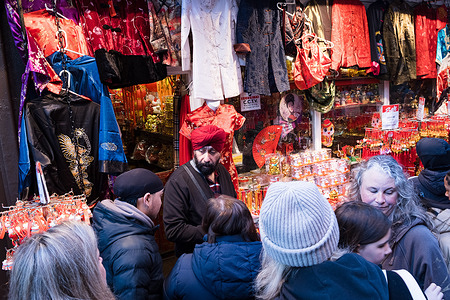 People gather around the street shop in Chinatown which sells traditional clothes and decorations to celebration the Lunar New Year. The Lunar New Year parade in London took place this weekend celebrating the Year of the Snake, it started from East of Trafalgar Square to Chinatown. The event is claimed to be the largest Lunar New Year outside Asia.