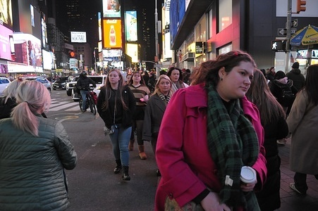 People walk in Times Square, Manhattan, New York City.