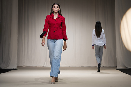 A model walks the runway wearing a design by MALAGA MODA during Momad Fashion Week de Madrid in IFEMA.