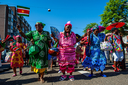 A group of Surinamese women seen dancing in traditional clothes. July 1, 1863, marked the end of slavery for the Surinamese. This parade is part of the 'Keti Koti' ('Broken Chains' in Surinamese) festival, which is opened with a colorful parade in traditional clothing called Bigi Spikri.