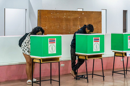 Voters cast their ballots behind green voting booths during Thailand's advance voting ahead of the 2026 general election at Imperial World Ladprao Shopping Mall, Wang Thong Lang District, Bangkok. Thai election advance voting is held one week before the general election, which in 2026 takes place on Sunday, 8 February, allowing registered voters to cast their ballots early if they cannot vote on election day.