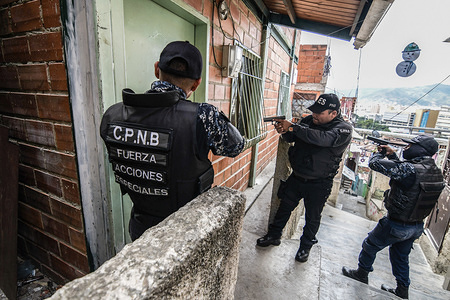 Members of the Bolivarian National Police Special Forces (‘FAES’ in Spanish) seen taking position during a Police raid operation against criminal groups at Petare slum in Caracas.