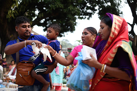 A Hindu family offers a pigeon at the Shri Shri Lokanath Brahmachari Ashram temple in Narayanganj outskirt of Dhaka.