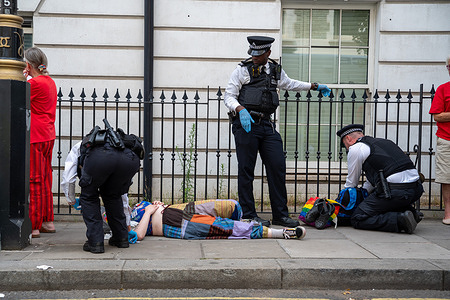 Metropolitan Police officers search Palestine Action supporters after they were arrested during a demonstration at Marylebone Road. Supporters of Palestine Action gathered outside Westminster Magistrates' Court to demonstrate in support of more than 1,000 people previously arrested who were due to appear before the courts on charges related to support for Palestine Action, a proscribed terrorist organisation under UK law. The Metropolitan Police imposed conditions under Section 14 of the Public Order Act during the demonstration. Officers made multiple arrests and removed protesters from the scene after allegedly breaching the conditions by vocally expressing support for the banned terrorist group.