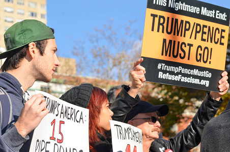A protester seen holding an anti-Trump placard during the demonstration.
Hundreds of protesters gathered at Washington Square Park in Manhattan to demand President Trump & Vice President Pence’s resignation during Trump/Pence Regime must go protest.
