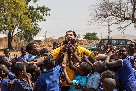 Children grab at an HRF representatives beard at TimTooni Football Club, just outside Tamale in Northern Ghana. 
Along with football coaches from London, time was spent with the children here teaching them new skills and ending with a big game of football. These areas of Ghana are so remote and the levels of poverty are some of the lowest in the world.