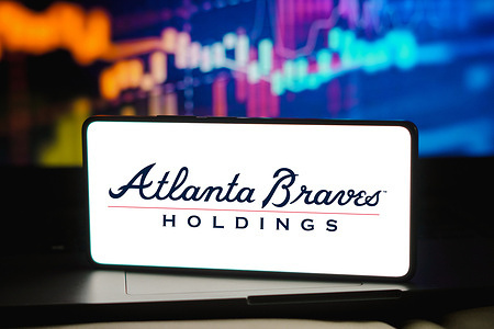 In this photo illustration, the Atlanta Braves Holdings logo is displayed on a smartphone screen.