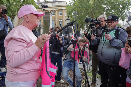 Lorraine Kavanagh, founder of the Pink Ladies, speaks at a rally outside Downing Street protesting against the housing of illegal migrants in hotels. The “Pink Ladies,” also known as the “Pink Protest,” held a demonstration in Westminster, London, to oppose the government’s policy of housing asylum seekers in hotels. The female-led group claimed to be raising concerns for the safety of women and children in affected communities, arguing that the influx of mostly male asylum seekers posed risks of violence and harassment. The protest, supported by figures linked to Reform UK, was met with a large counter-demonstration by Stand Up To Racism, who accused the group of using women’s safety as a cover for anti-migrant sentiment.