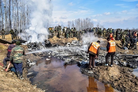 Firefighters spray water into the wreckage of an Indian military aircraft which crashed in Budgam, 20kms from Srinagar, Kashmir. An Indian Air Force aircraft crashed on Wednesday in Budgam district of Kashmir, killing seven persons including six Indian Air Force personnel and one civilian. The aircraft crashed due to technical reasons, officials said.