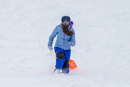 A teenager pulls her sled at "the knoll" on the campus of the Danville State Hospital.
A winter storm dropped more than a foot of snow over much of central Pennsylvania.