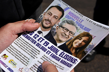 An activist distributes election leaflets with photos of the 2022 elections candidates Sebastien Delogu (L), Jean-Luc Melenchon (C), and Farida Hamadi (R). Legislative candidates Sebastien Delogu and Farida Hamadi and Far-left presidential candidate Jean-Luc Melenchon represent the New Popular Union Ecological and Social (NUPES). French election 2022 will take place on June 12 and 19.