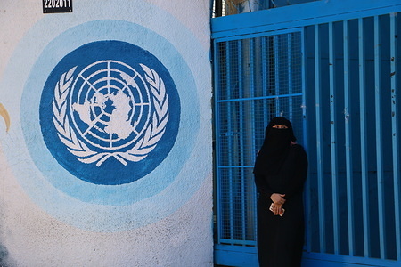 A woman stands in front of UNRWA headquarters during the protest.
Palestinian employees of UNRWA (United Nations Relief and Works Agency) take part in a demonstration against job cuts (more than 250 jobs cut) announced by the agency outside the offices in Gaza.