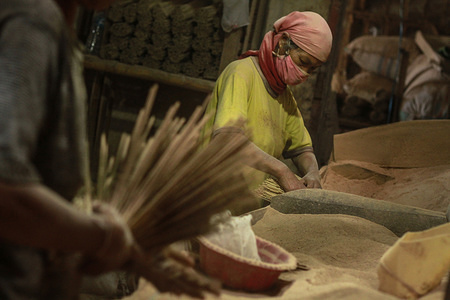 MALANG, INDONESIA - JANUARY 16 2020: Traditional incense in the making.
As the Chinese New Year approaches, incense demand is increasing and workers who use improvised masks have to go an extra mile.