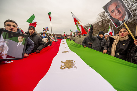 Pro-Reza Pahlavi demonstrators with Flags, posters and placards march during the protest. Around 200 to 300 Reza Pahlavi supporters gathered on the Malieveld in The Hague, in temperature that felt like (-8) degrees. They gathered to show their support for the exiled son of Iran's last shah (king). Now at 65 and living in a quite suburb of Washington D.C. and once again seeking a roll in his country’s future and his calling for the people to take to the streets. Since the 28 December anti-government protests have been taking place in numerous Iranian cities. Two human rights groups reporting at least 50 protesters have been killed, including seven children and 21 security personnel and more than 2,311 individuals arrested. Iranians have many grievances against their government, from political freedom, corruption, the state of the economy and crippling prices rises, mostly brought on by heavy U.S. sanctions.