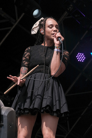 Marcia Richards, female vocalist, alto saxophone and melodica player with British reggae punk band The Skints seen performing live on the Grand Central stage during the Fair Festival. Boomtown is a British music festival held every year on the Matterley Estate in South Downs National Park, near Winchester.