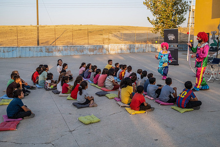 Pre-movie clowns entertain kids at the school garden. Batman Culture and Art Association organizes a cinema event that introduces cinema to children who have not met cinema yet in the villages of Batman district. The association screened Hayao Miyazaki's animated film "My Neighbor Totoro" with Kurdish language dubbing.