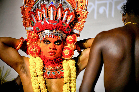 A Theyyam artist from Kerala prepares at the 66 Pally Durga Puja Committee in Kolkata during the Durga Puja celebration. Durga Puja, also called Durgotsava or Sharodotsav, is an annual Indian festival honoring the Hindu goddess Durga. During their celebration, the 66 Pally Club Durga Puja Committee showcased Kerala Tourism with performances of traditional Theyyam dances.