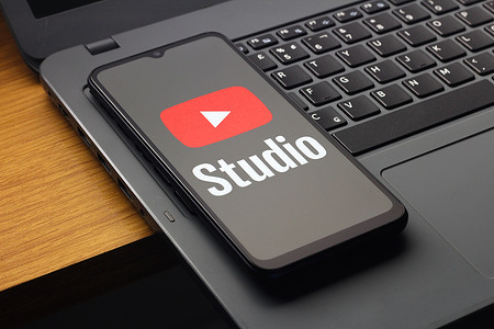 In this photo illustration, the YouTube Studio logo is seen displayed on a smartphone screen.