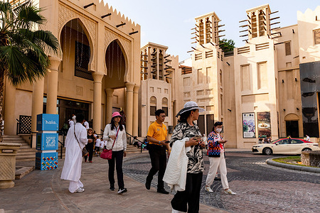 Tourists walk along the alleys of Souk Madinat Jumeirah, a market in an old part of the city in the center of Dubai.