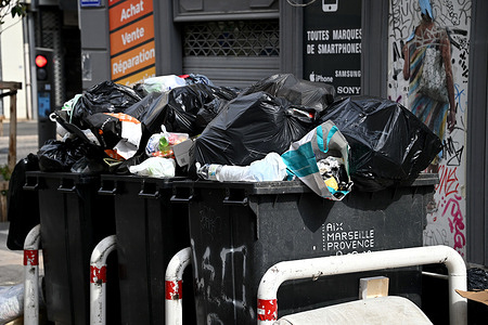 Overflowing garbage containers on Rue Sainte Victoire in Marseille.