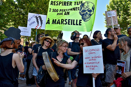 Protesters hold a banner and placards during the demonstration. People gathered in Place Bargemon to demonstrate against maritime transport pollution in Marseille.