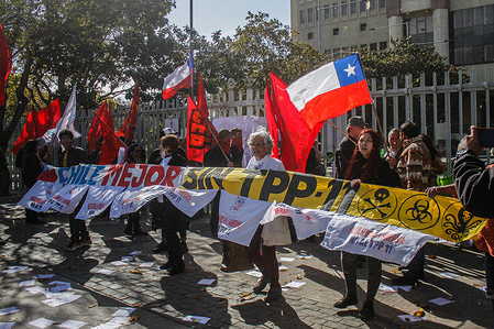 Protesters hold Chilean flags and banners against the Transpacific Agreement TPP-11 outside the National Congress. On Tuesday afternoon, the Senate approved the project that ratifies Chile's accession to the Comprehensive and Progressive Treaty of Trans-Pacific Partnership (CPTPP), a trade agreement better known as TPP-11. The initiative was approved by 27 votes in favor, ten against, and one abstention.