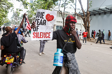 A protester holds a placard during a protest. The protesters took to the streets, with thousands making their way to the central business district in the capital, Nairobi to mark one year since the anti-tax demonstrations and to commemorate those who lost their lives on 25th June 2024.