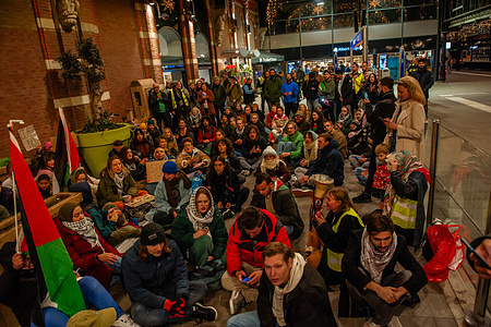 Supporters of Palestine are seen sitting on the ground during the demonstration. At the main hall of the central train station in Nijmegen, around two hundred pro-Palestine supporters sat on the ground to keep demanding a ceasefire in Gaza. These Pro-Palestinian actions have been organized around rush hour in several train stations across the country.