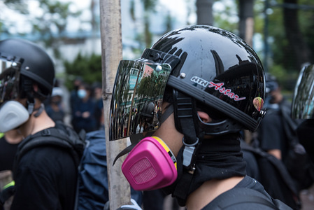 Protesters carry bamboo rods as they walk along the road after a police dispersal operation.
Protesters marched through various districts in Hong Kong in the latest round of protests. While the demonstration began peacefully, riot police arrived later on to conduct a dispersal operation, resulting in several arrests. Anti-government protesters continue to make their '5 demands' heard as they continue to defy government and police warnings week after week.