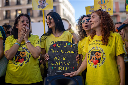 A protester, an early childhood educator, holds up a placard during a rally. Early childhood educators in Madrid, who work with children aged 0 to 3, demonstrated in Plaza Callao under the slogan "Funeral for nurseries," demanding better wages and an end to job insecurity.
