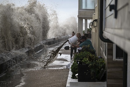 Long Beach Residents seen scooping water out as a massive wave from Hurricane Marie approaches. Hurricane Marie makes landfall in Long Beach, California.