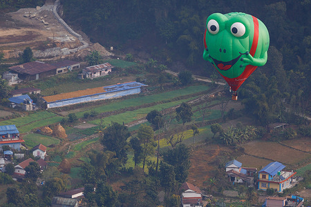 A hot air balloon soars above Pame on the inaugural day of Nepal's First International Balloon Festival in Pokhara. Organized by Balloon Nepal, the festival runs from December 23 to January 1, coinciding with Christmas and New Year, to promote tourism. Professional pilots from various countries are participating in this festival.