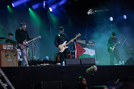Barry Burns (L), Dominic Aitchison (C) and Stuart Braithwaite (R) of Mogwai perform on stage during the Rock en Seine festival. The Scottish post-rock band Mogwai perform live on stage displaying a Palestinian flag in the last day of the Rock en Seine 2026 music festival at the Parc Saint-Cloud, in Paris.