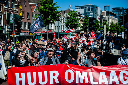 Hundreds of protesters are seen marching behind the motto 'Rent down'. Under the motto 'Rent down!' banner during the rally. Under the motto 'Rent down!'. The housing movement, a coalition of tenant organizations, residents' groups, and activists, took action to demand lower rents and find a solution to the shortage of affordable housing.