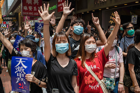 Protesters gesture the five demands sign during demonstrations against the draft bill.
Hong Kong police fired teargas and pepper spray onto demonstrators after thousands took to the streets in Causeway Bay protesting against Beijing declaration that it intends to impose national security laws.